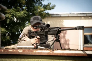 A soldier on top of the building is holding a Long range rifle M12 M made by zastava arms